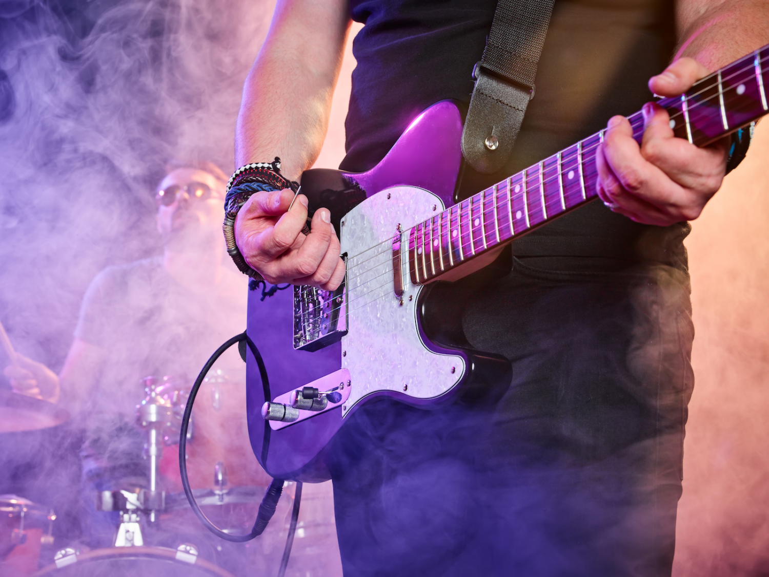 Guitarist and drummer performing music